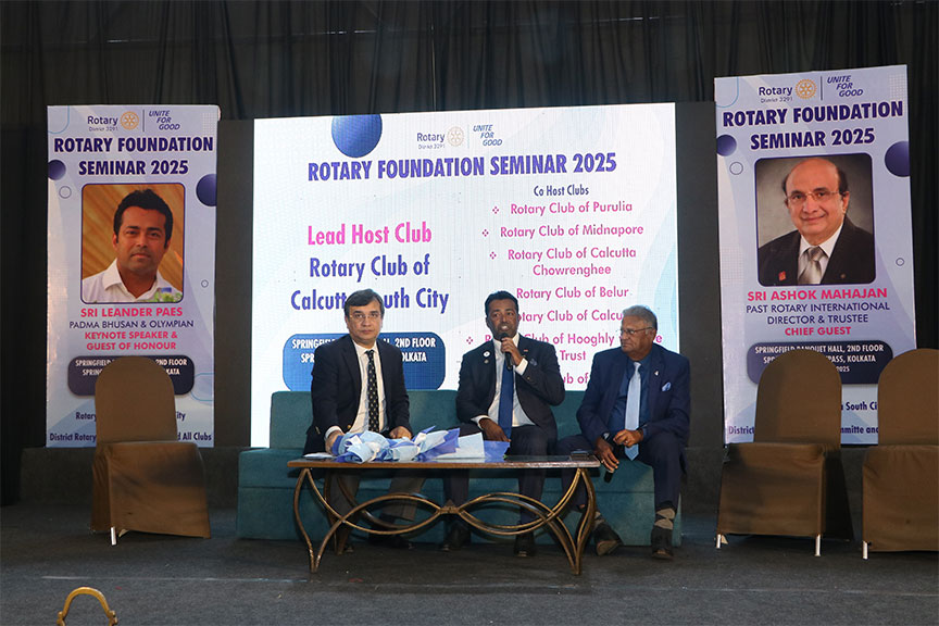 Premium conference setup with rows of chairs and branded podium, Kochi